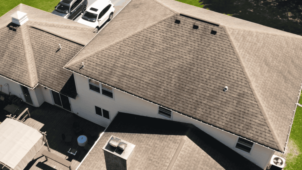 Aerial view of a residential shingle roof during a professional home inspection.